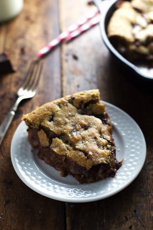 Deep Dish Chocolate Chip Cookie slice on a white plate.