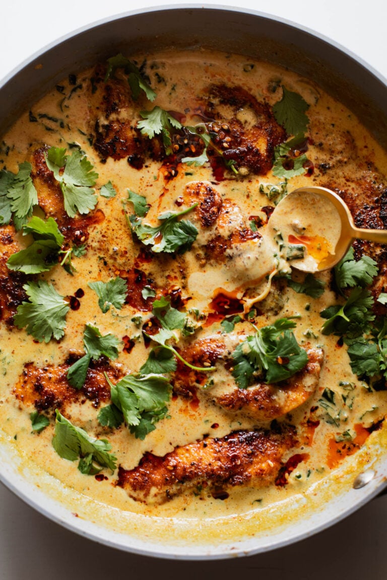 Coconut chicken in a skillet.