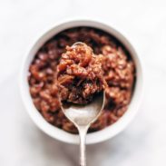 Caramelized Shallot and Grape Chutney in a jar with spoon.