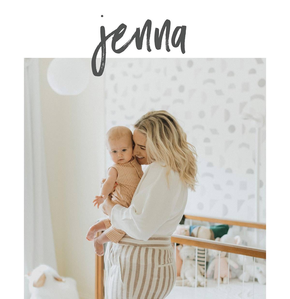 Woman holding her kid with a broad smile.