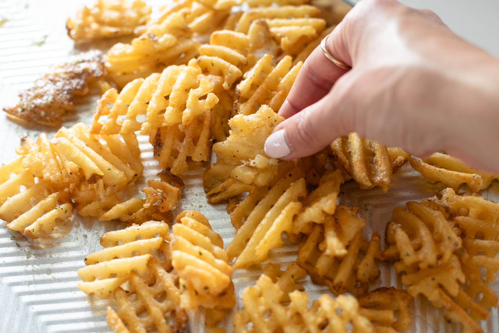 Waffle fries on a sheet pan.