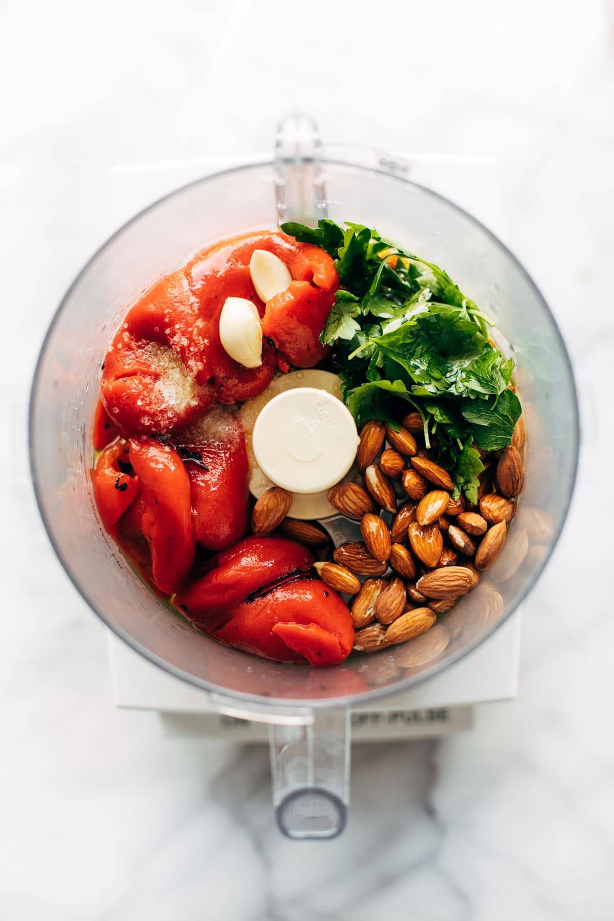 Red pepper sauce ingredients in a food processor.
