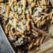 Mushroom Alfredo Pasta Bake in a pan with a spoon.